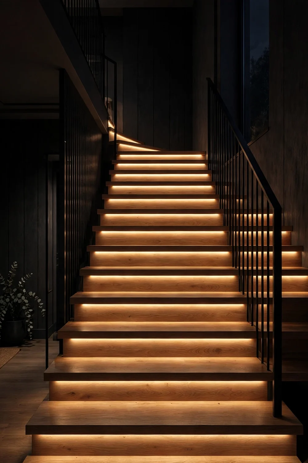 Modern staircase at night with warm LED lights recessed under each stair tread